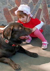 girl in red and brown labrador