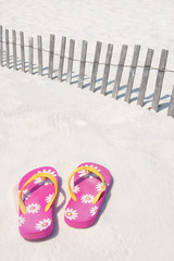 flip flops on sand dune