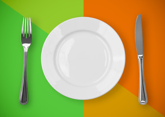 Knife, plate and fork on colorful background