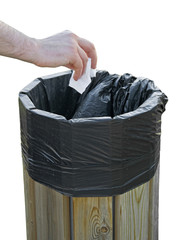 Hand throwing crumpled paper in the litterbin.