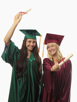 two female college graduates in cap and gown.