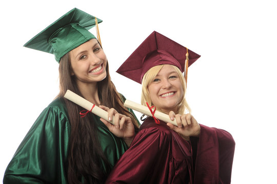 two female college graduates in cap and gown.