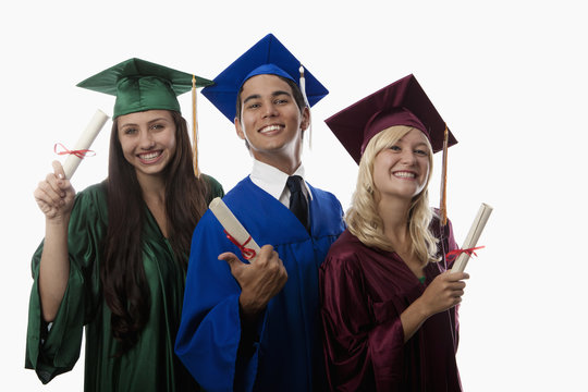 asian man and two women graduates in cap and gown