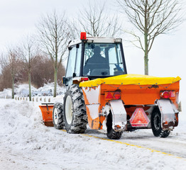 Tractor removes snow in a park