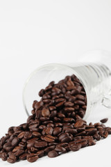 Glass with spilled coffee beans