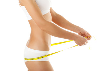 Woman measuring her slim body isolated on white