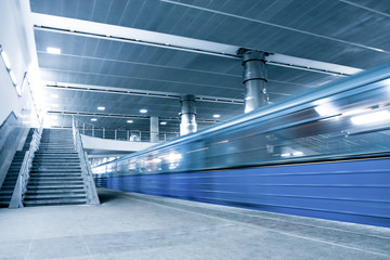 blue moving train with staircase