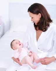 Mother holding baby and looking at him