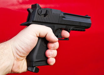 Human hand holding gun