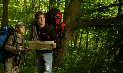 Father and son hiking in forest
