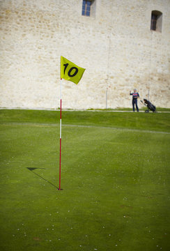 Yellow Flag Hole Marker Number Ten, At The Golf Course.