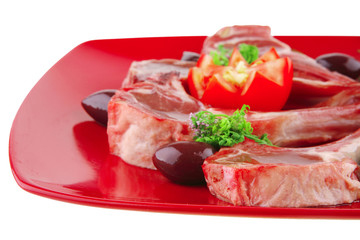 uncooked ribs on red plate