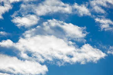 Naklejka na ściany i meble Fleecy clouds on blue sky background