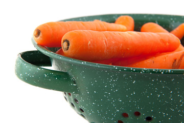 Green colander with fresh carrots