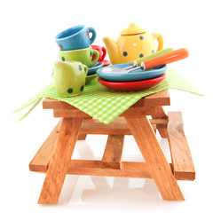 Wooden picnic table with crockery