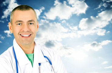 The smiling doctor against the sky