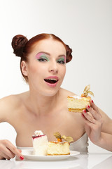 The beautiful young woman eat tasty cake