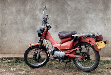 Stationary red motorcycle, Tanzania, Africa