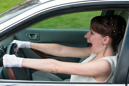 Woman in white dress driving a car and screaming
