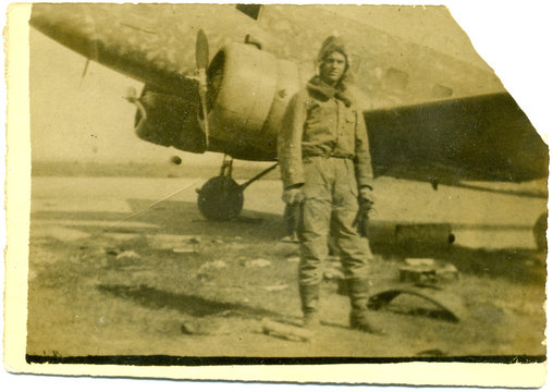 man near old airplane
