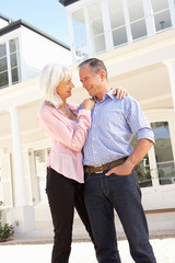 Senior Couple Standing Outside Dream Home