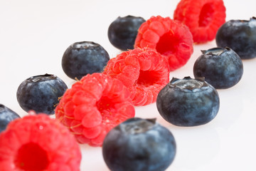 Raspberries and blueberries in a row