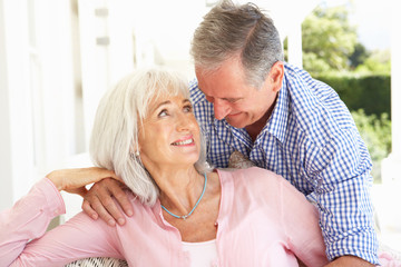 Portrait Of Senior Couple Relaxing Together On Sofa