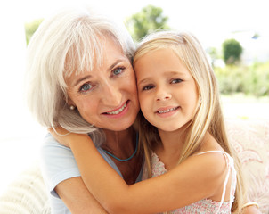 Portrait Of Grandmother With Granddaughter Relaxing Together
