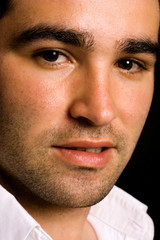 Obraz premium Close up Portrait of young attractive man on a black background