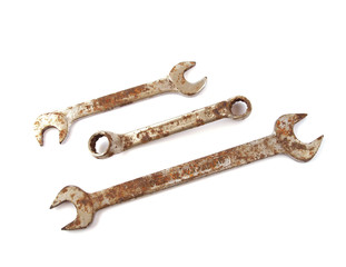 Rusty spanner on a plane white background.
