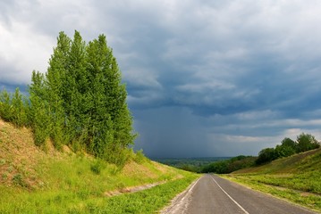 Fototapeta na wymiar asphalt doad among a green hills