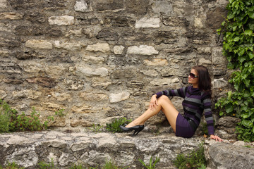 fashion woman posing on a rock
