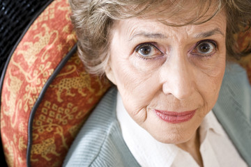 Face of serious elderly woman staring at camera