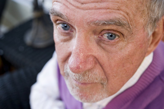 Face Of Serious Elderly Man Staring At Camera