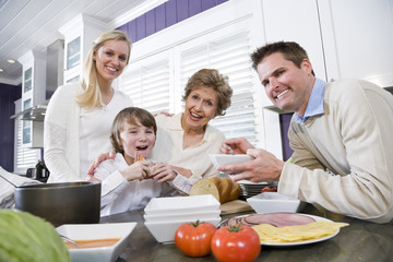 Three generation family in kitchen eating lunch