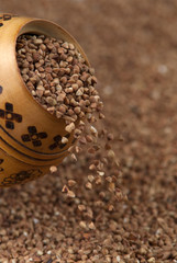 buckwheat falls from a wooden pot
