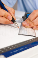 Architect working on architectural plans in the office