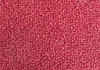 Texture of a maroon door mat