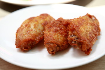 Plate of crispy, delicious fried chicken .