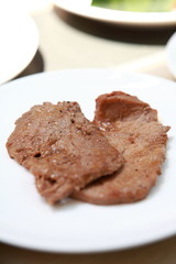 a steak with in a white plate