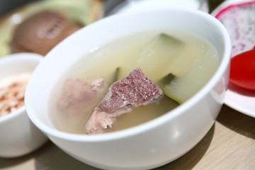 bone soup in a white bowl on table