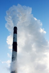 Smoking stack of thermal power station against a blue sky