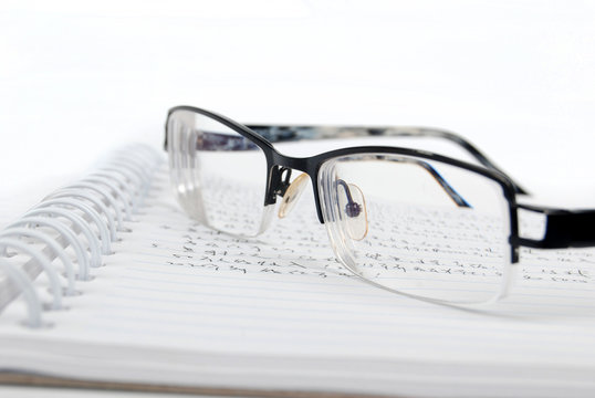 notebook & pen with glasses