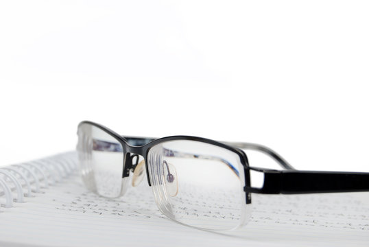 notebook & pen with glasses