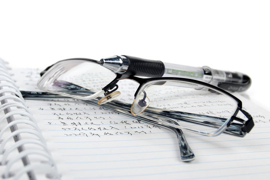 notebook & pen with glasses
