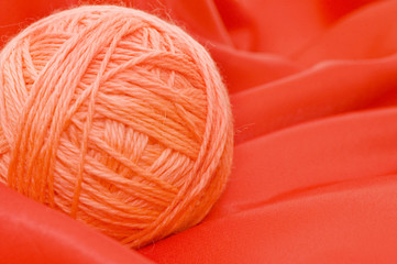 Ball of threads on a red fabric