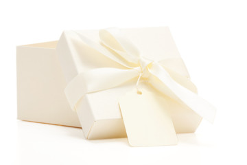 cream colored gift box with bow and name tag