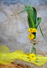 Still-life - bouquet with yellow flowers in phial