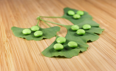 pills on a ginkgoleaf