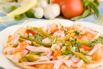 Pizza with ham, olives and capsicum pepper